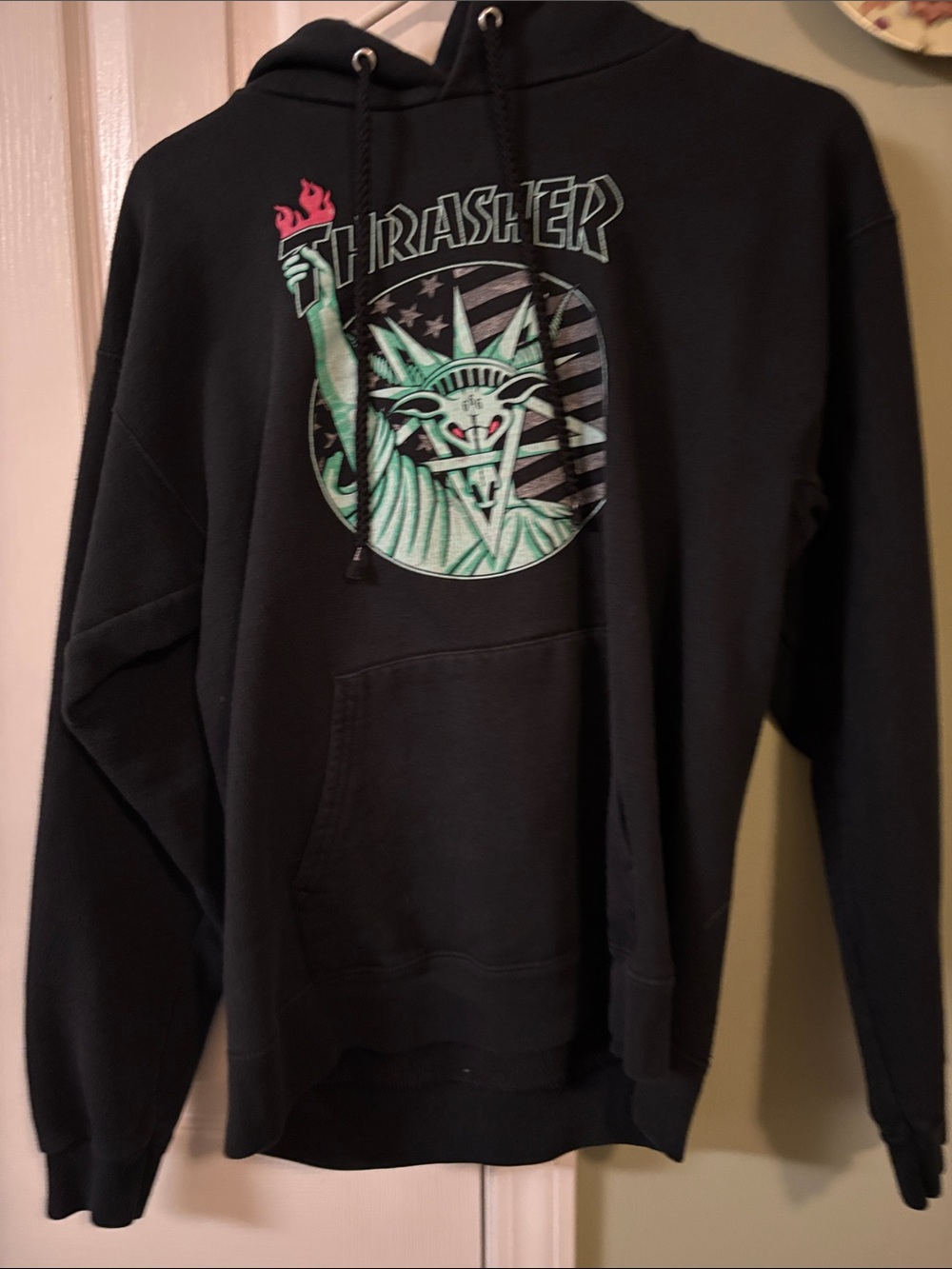 Thrasher Black Hoodie with Green Statue Graphic and Red Torch